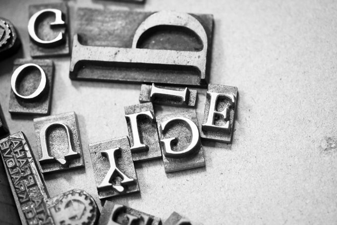 Antique printing press letters close-up metallic color